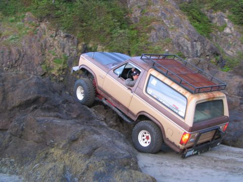 1983 Ford Bronco - This 1983 Ford Bronco is shown tackling a challenging rocky beach, demonstrating its off-road capabilities.