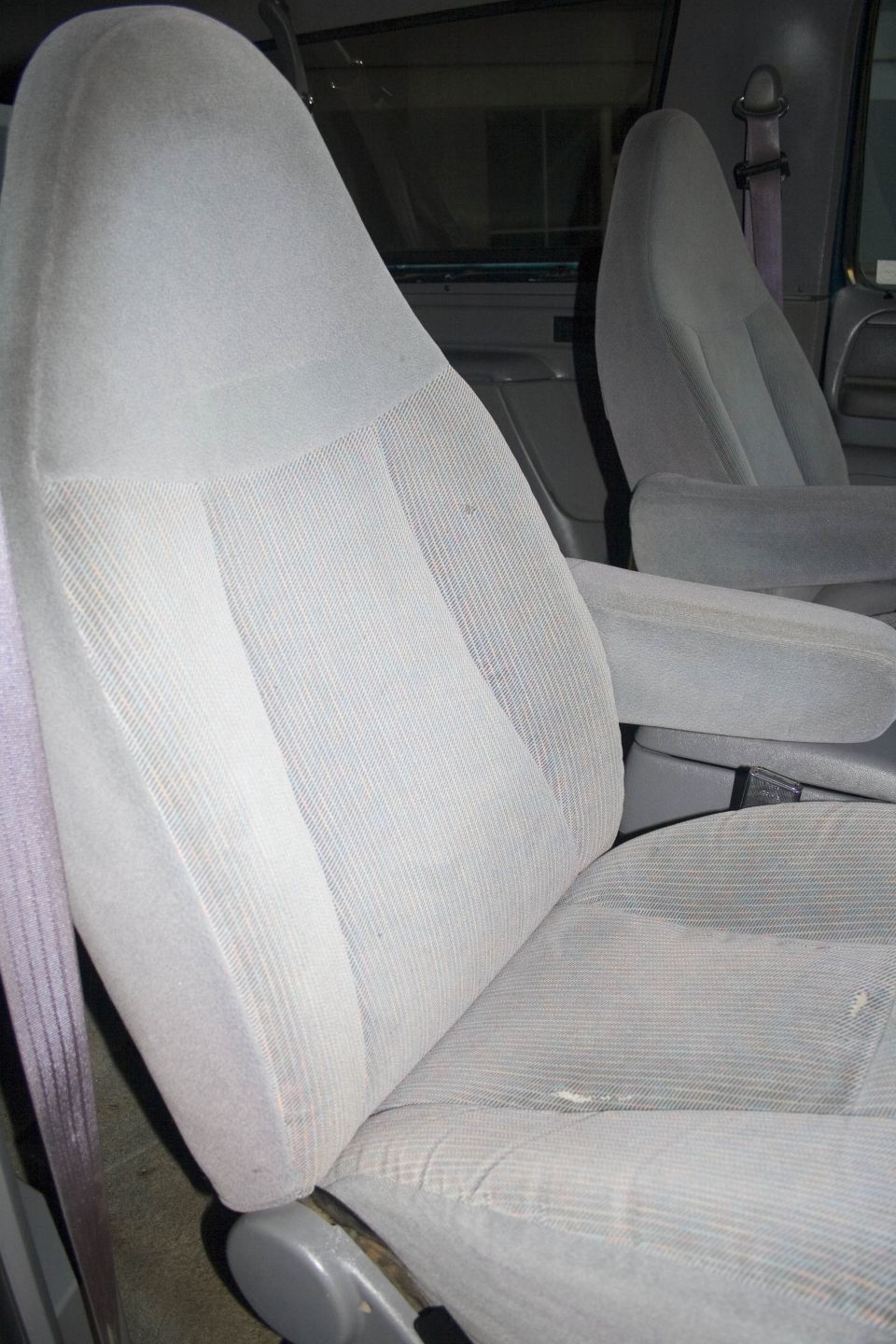 Gray cloth bucket seats and console inside a truck cab