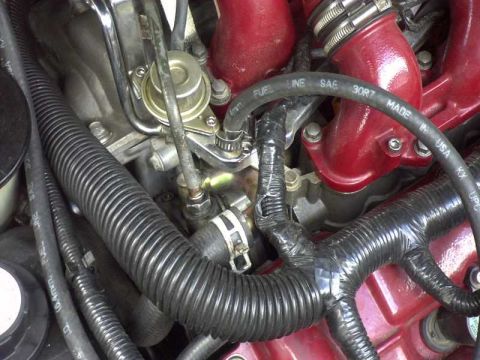 1997 Ford Taurus - Close-up of engine intake components including hoses and fuel line.