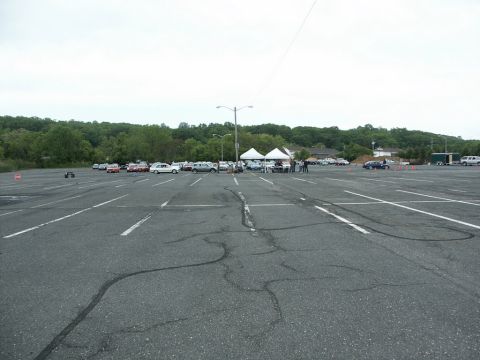 2001 Mercury Grand Marquis - Cars are gathered in a parking lot, with some participating in a course marked by cones.