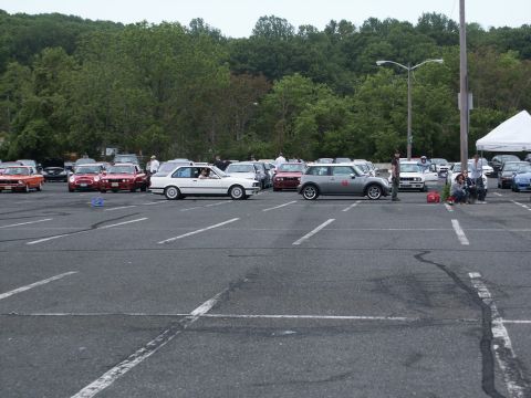 2001 Mercury Grand Marquis - A gray Mini Cooper with red racing numbers is parked in a lot alongside other vehicles.