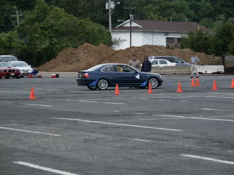 2001 Mercury Grand Marquis - A blue coupe with racing number 4 is seen on a track with orange cones, other vehicles in background.