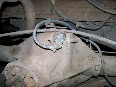1995 Ford Bronco - Close-up view of a vehicle's rear differential and associated sensor.