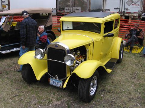 1989 Ford Mustang - A yellow hot rod with a custom license plate is parked outdoors.