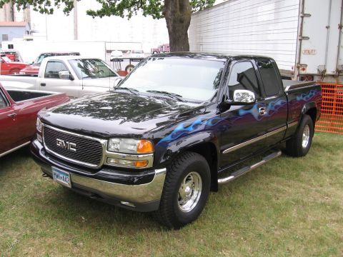 1989 Ford Mustang - This GMC pickup truck features custom blue flame graphics and chrome accents.