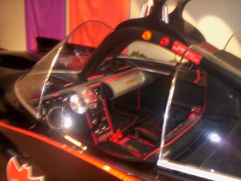 1989 Ford Bronco - Interior view of a custom car with red accents on the seats and dashboard.