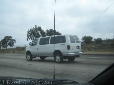 1968 Ford Mustang - A white 4x4 van is seen driving on the highway.