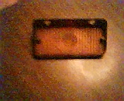 1972 Ford Ranchero - This is a close-up of an amber marker light assembly, likely for a vehicle.