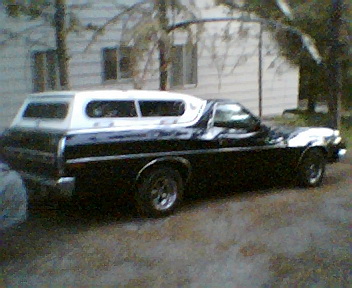1973 Ford Ranchero - This 1973 Ford Ranchero is equipped with a white camper shell, offering a unique combination of utility and passenger space.