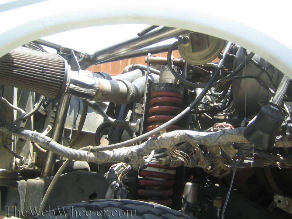 Engine bay with cone filter and red coil-over springs