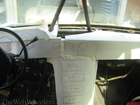 1990 Ford Bronco - Interior view of a stripped vehicle with a paper dash template marked A/C, SJ, FM RAD and CB for switch layout.