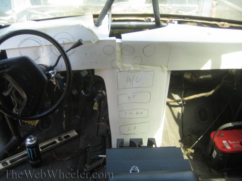 1990 Ford Bronco - Bare vehicle interior showing steering wheel, gutted dash and a paper template marked A/C, SJ, FM RAD and CB.