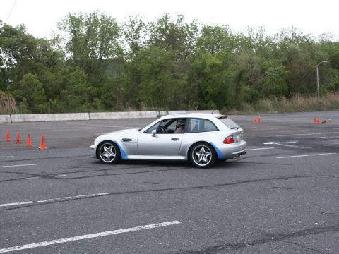 2001 Mercury Grand Marquis - A silver BMW Z3 M Coupe with distinctive blue accents navigates an autocross course.