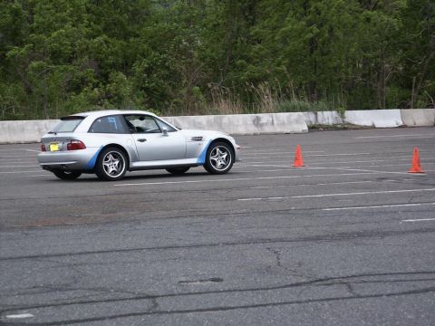 2001 Mercury Grand Marquis - Silver BMW Z3 coupe navigates a course marked by orange cones on a paved track.