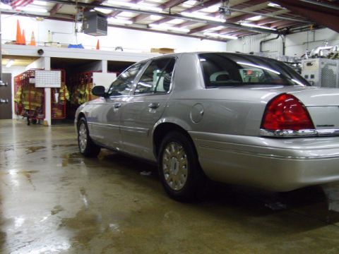 2004 Ford Crown Victoria - Silver 2004 Ford Crown Victoria parked inside a building with fire department gear visible.