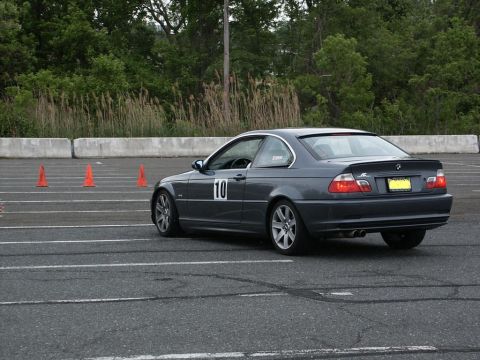 2001 Mercury Grand Marquis - A dark gray coupe with racing number 10 on its door navigates an autocross course.