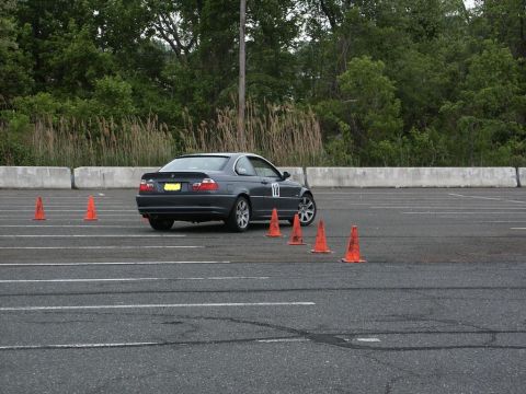 2001 Mercury Grand Marquis - A BMW 3 Series coupe is seen from the rear on an autocross course, marked with the number 10 and surrounded by cones.
