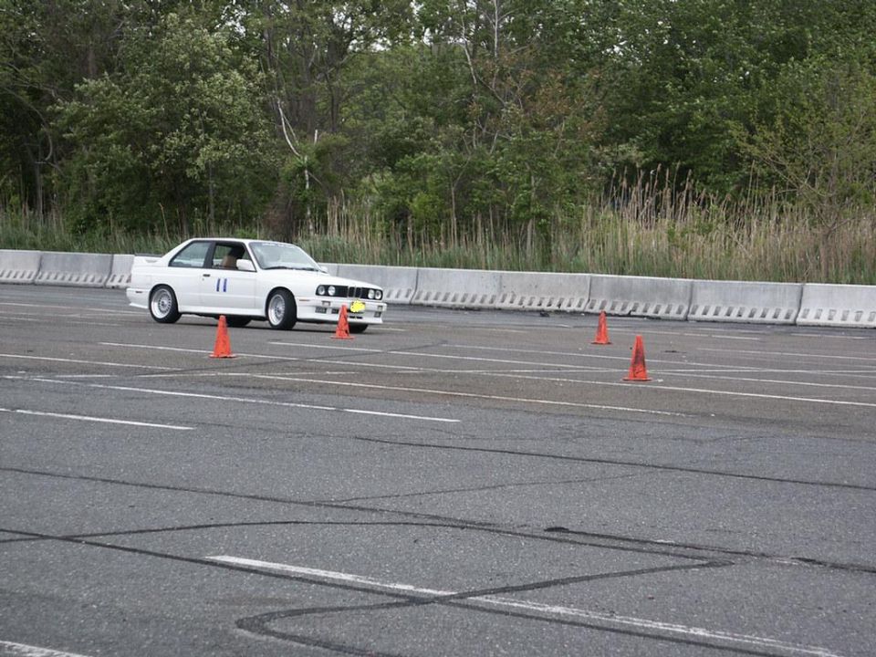 White BMW E30 M3 with racing number 11 on track