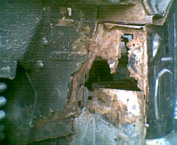1973 Ford Ranchero - Extensive rust damage is visible on the vehicle's structural components.