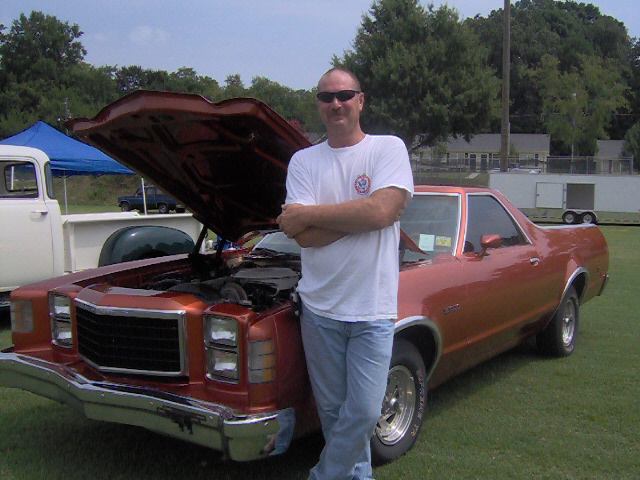 Copper 1978 Ford Ranchero with hood open, man standing beside it