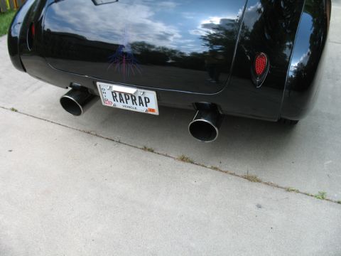 1940 Chevrolet Suburban - Black car's rear end with dual exhaust and custom Ohio license plate.