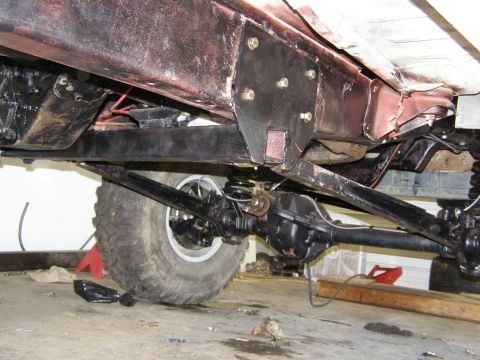 1993 Ford Bronco - Undercarriage view of a vehicle's rear axle and suspension components.