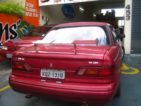 1995 Ford Taurus - This 1995 Ford Taurus features a rear spoiler and V6 24V badging, seen from the rear.