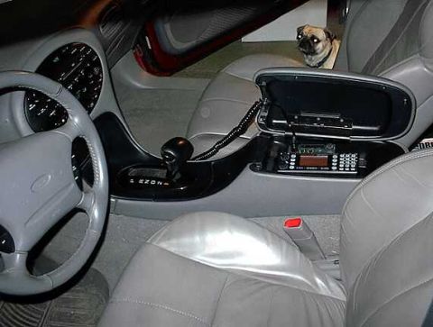 1997 Ford Taurus - Interior view of a 1997 Ford Taurus, complete with a pug and aftermarket radio equipment.