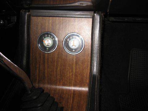 1968 Shelby GT500 - The interior of a 1968 Shelby GT500 shows woodgrain trim, two gauges, and a manual shifter.