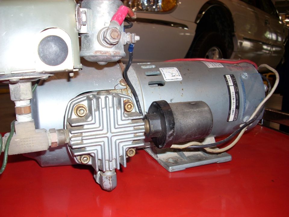 Air compressor motor with silver casing and black cap