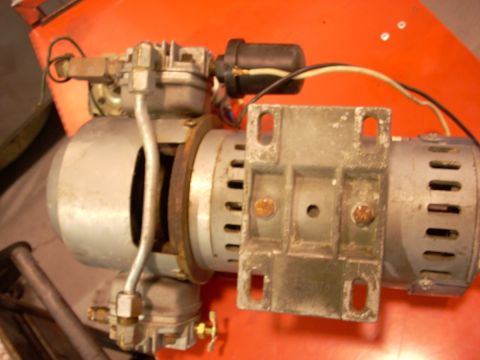 1992 Ford Bronco - Close-up view of an engine component, possibly a carburetor and ignition coil assembly.