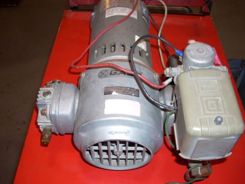 1992 Ford Bronco - Close-up of an air compressor motor assembly, showing its various components and wiring.