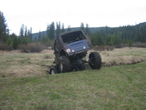 1995 Ford Bronco - Off-road vehicle stuck in a ditch during an outdoor excursion.