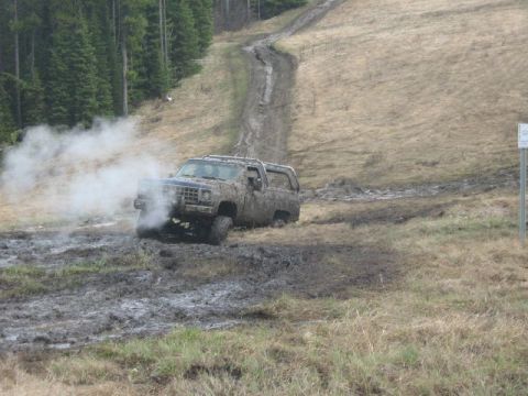 1995 Ford Bronco - This SUV is stuck in the mud on a steep, off-road trail.