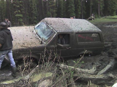 1995 Ford Bronco - A 1995 Ford Bronco is stuck deep in the mud during an off-road event.