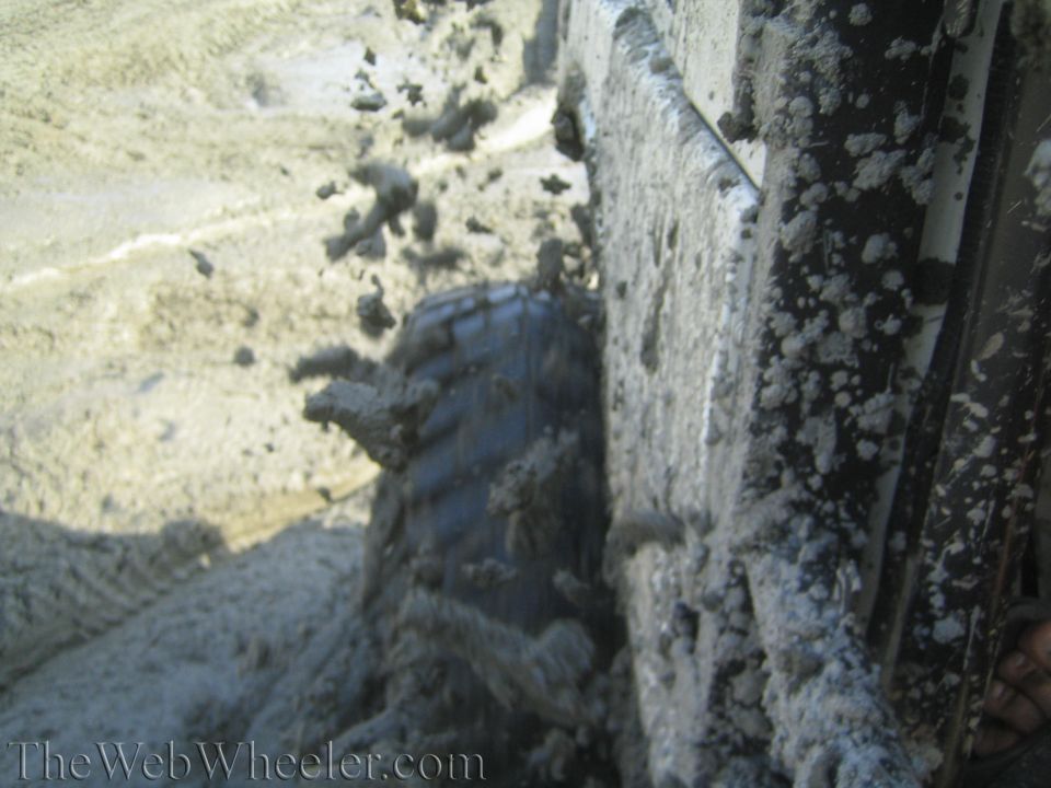 1987 Suzuki Samurai side view, tire stuck in mud