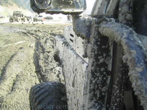 1987 Suzuki Samurai - Multiple vehicles navigating a muddy off-road course.