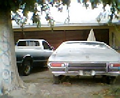 1973 Ford Ranchero - Rear view of a silver 1972-1979 Ford Ranchero parked in a driveway next to a pickup truck.