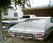 1973 Ford Ranchero - Rear view of a 1973 Ford Ranchero, parked outdoors with another vehicle nearby.