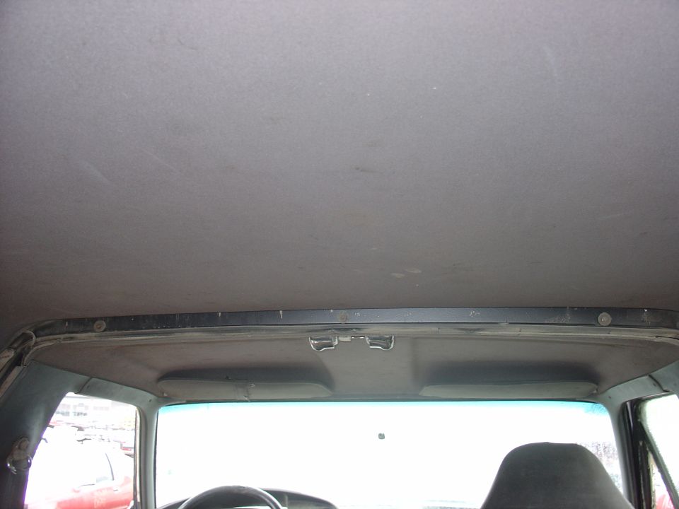 Interior view of a car's headliner and upper windshield area. A watermark reads 'SUPERMOTORS.NET'
