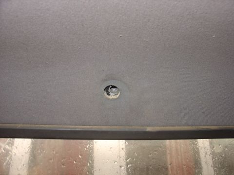 1988 Ford Bronco - Interior view of a vehicle headliner showing a hole, possibly for a light or accessory.