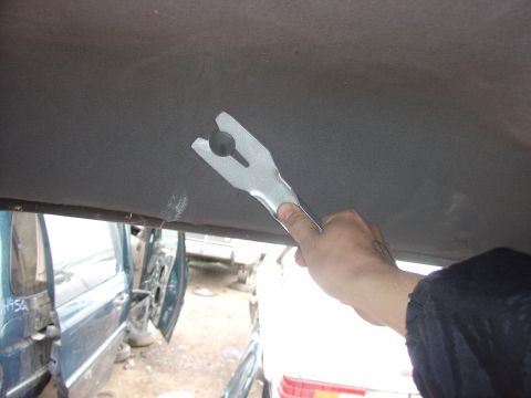 1988 Ford Bronco - Tool used for removing interior trim panels from a vehicle's headliner.