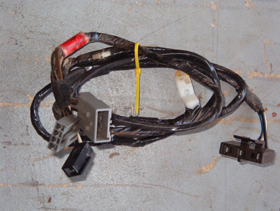 Used automotive wiring harness with connectors on concrete floor