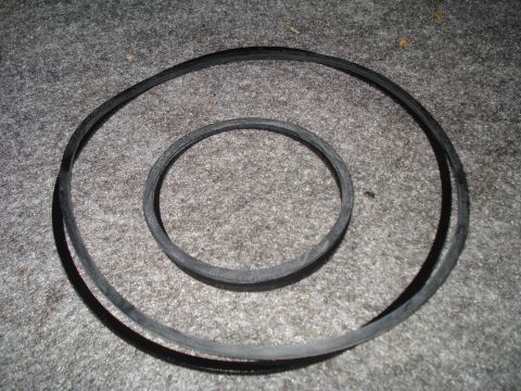 1984 Ford Bronco - Two rubber belts are shown on a carpeted surface, possibly for vehicle maintenance.