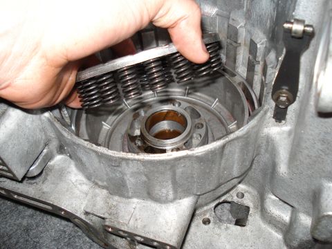 1984 Ford Bronco - A hand holds springs during a transmission rebuild, showing internal components.