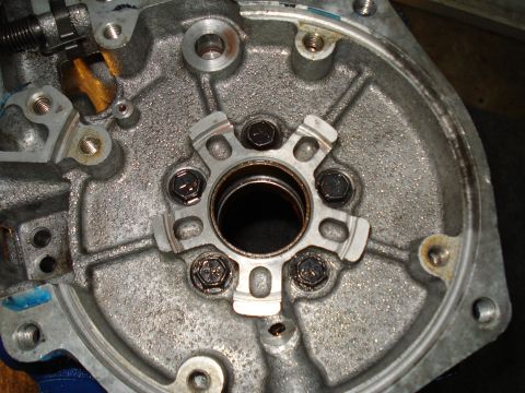 1984 Ford Bronco - Close-up of a metal transmission housing, showing internal components and bolt heads.