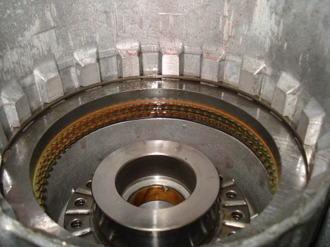 1984 Ford Bronco - Internal view of a transmission clutch pack, showing worn friction plates and housing components.