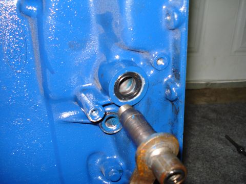 1984 Ford Bronco - Close-up of a blue engine block component with a seal and metal shaft, a Supermotors logo.