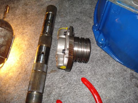 1984 Ford Bronco - Close-up of a transmission part and a driveshaft, likely for a vehicle rebuild.