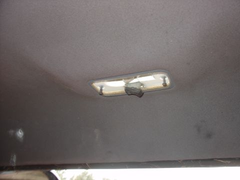 1988 Ford Bronco - Close-up of a vehicle's interior dome light assembly.